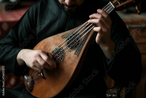 Close-up of a musician playing a traditional stringed instrument, focusing on the hands and instrument. photo