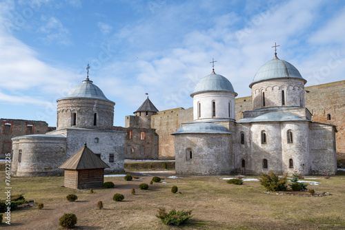 View of the ancient Assumption and St. Nicholas churches in the Ivangorod fortress on a sunny March day. Leningrad region, Russia photo