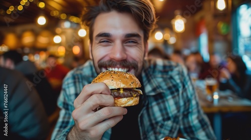 Happy man enjoying a burger and having a good time 