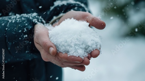 an adult is holding a piece of snow in his or her hand