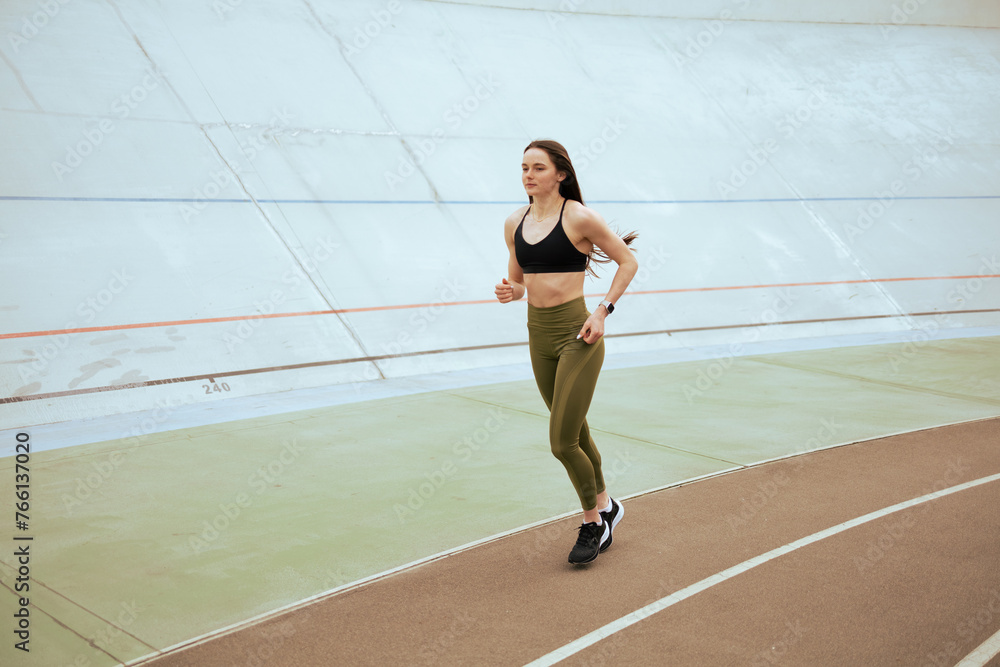Fototapeta premium Athletic girl run an training in stadium.