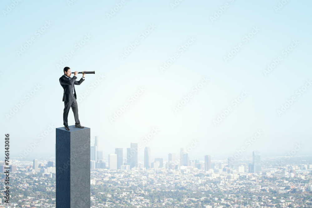 Side view of young businessman on concrete bar looking into the distance with telescope. Bright blue sky and city background. Strategy, forecast and goal concept. Mock up place for advertisement. Side view of young businessman on concrete bar looking into the distance with telescope. Bright blue sky and city background. Strategy, forecast and goal concept. Mock up place for advertisement.