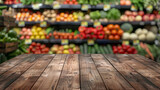 Wooden board empty table in front of blurred background. Perspective dark wood table over blur in supermarket fruits and vegetables shelf. Mock up for display