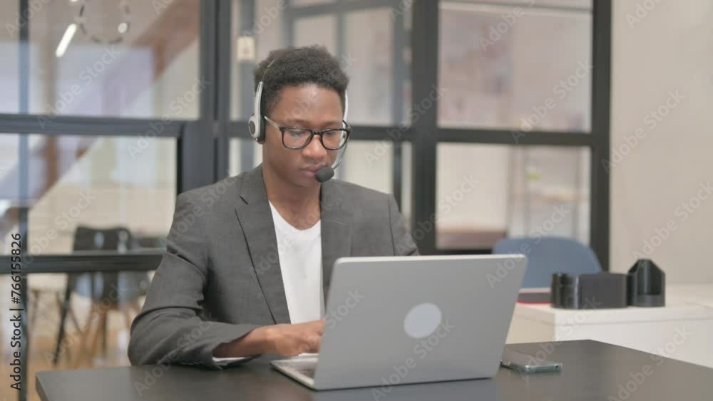 African American Man with Headset Working on Laptop African American Man with Headset Working on Laptop
