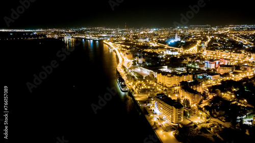Astrakhan, Russia. Volga river, Petrovskaya embankment. Night city lights, Aerial View photo