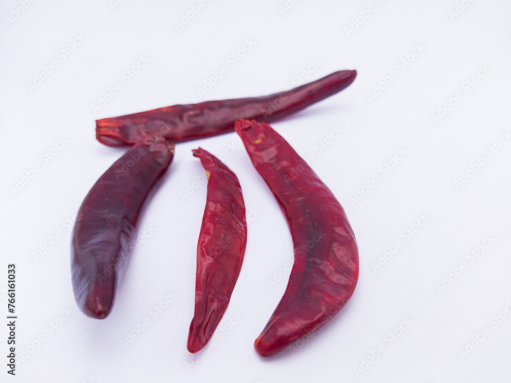 some red dried chillies with white background some red dried chillies with white background