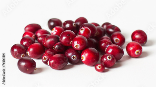 A cluster of vibrant cranberries scattered on a white background, showcasing their deep red color and glossy texture.