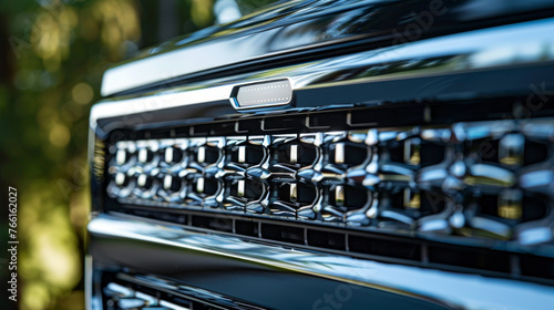 A sleek aluminum grille insert, with intricate patterns and a polished finish, adding a touch of style to the truck's front end