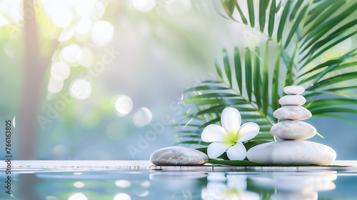 Spa setting with stacked stones and frangipani flower, serene water and palm leaves, zen wellness atmosphere