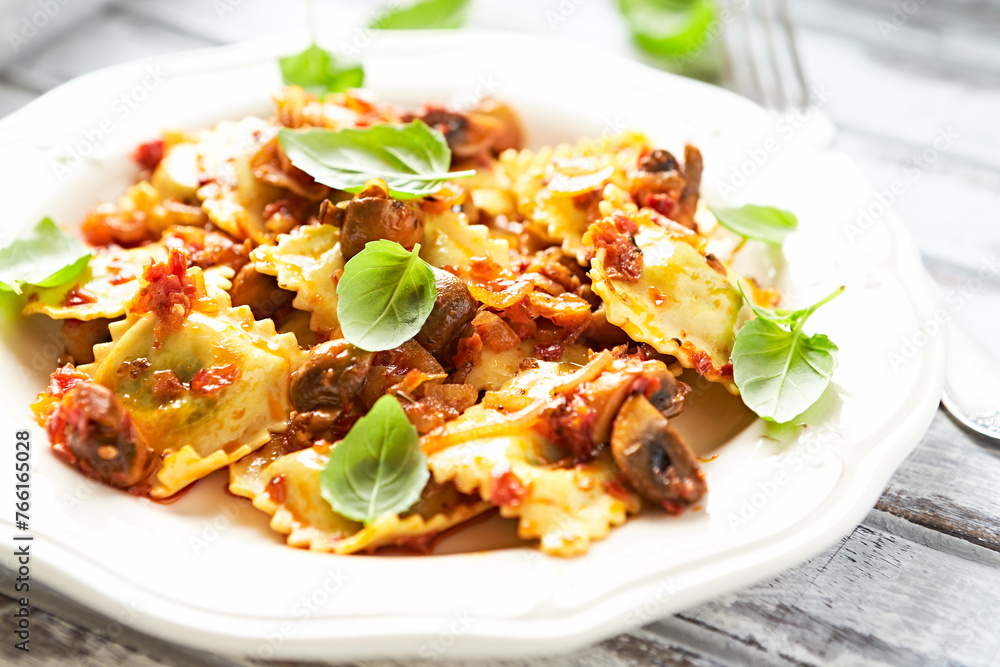 Ravioli with mushrooms and fresh basil. Bright wooden background. Close up. Ravioli with mushrooms and fresh basil. Bright wooden background. Close up.