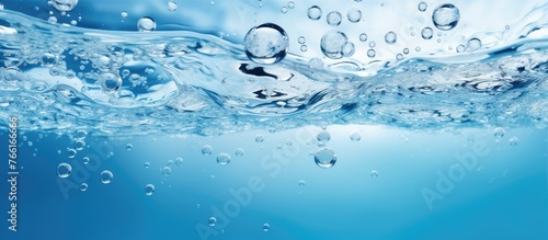 A close up of water with bubbles in it, resembling a liquid azure cloud in the atmosphere. A beautiful natural landscape showcasing the fluidity of water resources