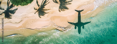 An airplane soars above a sandy beach, leaving a trail of clouds in its wake