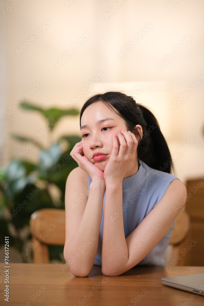 Asian college students are stressed out Sitting in front of a laptop studying online through a video calling program on a laptop at home. Asian college students are stressed out Sitting in front of a laptop studying online through a video calling program on a laptop at home.