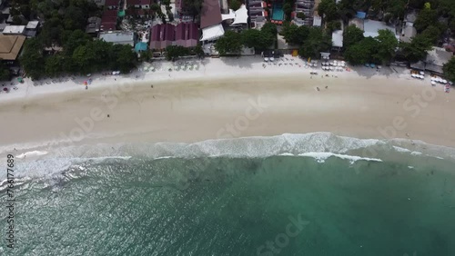 Aerial view of ocean waves crashing on a white beach. of the tropical coast Koh Samet, Thailand