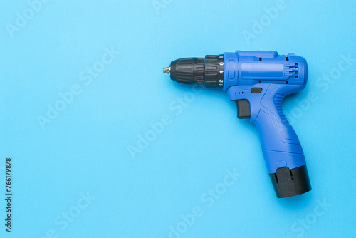 An image of a blue screwdriver on a blue background with a place for your text.