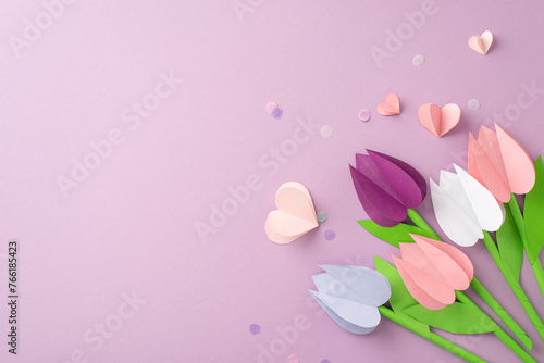 Crafting love for Mom. Top-view snapshot of folded paper tulips, small hearts, and fine confetti on a pastel violet background, reserving space for words