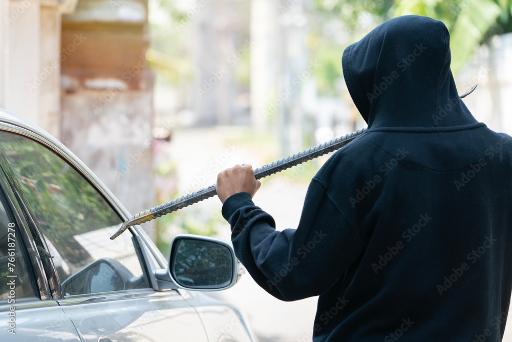 side view of car thief in action side view of car thief in action