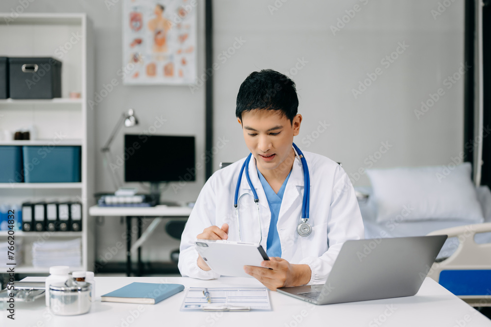Doctor sit on table in office hospital. Attractive therapist female practitioner pharmacist smile and use tablet and laptop. after success work from treatment Doctor sit on table in office hospital. Attractive therapist female practitioner pharmacist smile and use tablet and laptop. after success work from treatment