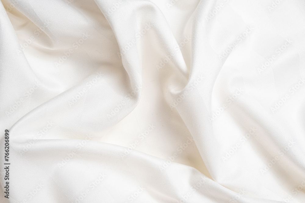Fototapeta premium Waves and patterns of crumpled natural satin white milk color fabric.