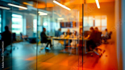 Blurred office with people people behind glass