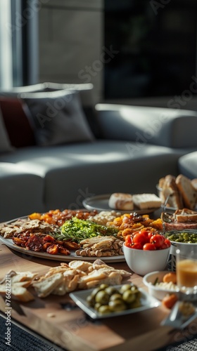 Assorted mediterranean dishes on a wooden table in a cozy home setting