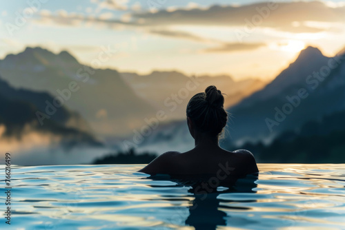 Woman happily swims in a pool with mountains under a sunset sky. Generative AI photo