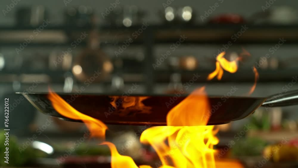 Super Slow Motion of Empty Pan with Fire. Filmed on High Speed Cinema Camera, 1000 fps. Kitchen with Utensils on Background. Super Slow Motion of Empty Pan with Fire. Filmed on High Speed Cinema Camera, 1000 fps. Kitchen with Utensils on Background.