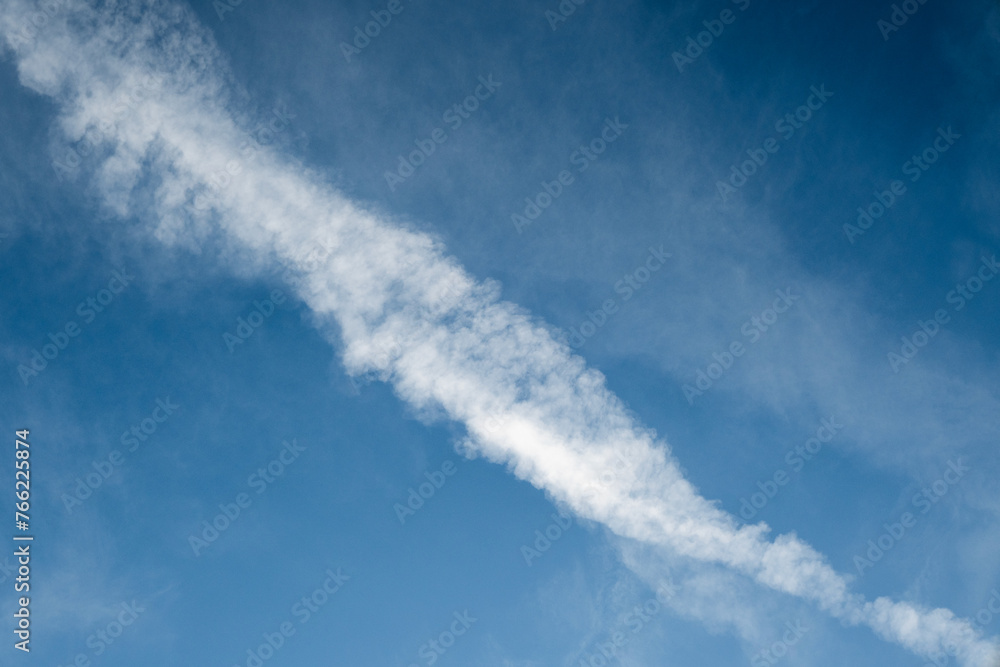 Contrails, vapor trails from the airplane with a blue sky background Contrails, vapor trails from the airplane with a blue sky background