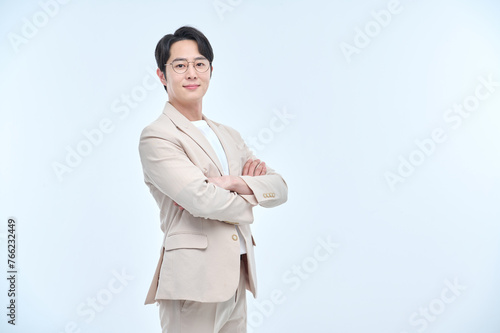 A young office worker man wearing a suit and glasses is posing with various facial expressions.