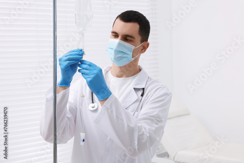 Doctor setting up IV drip in hospital