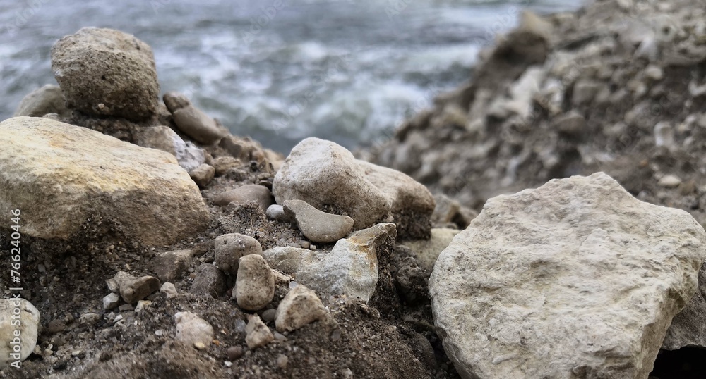 Rock Formation by Beach With Water in Background Rock Formation by Beach With Water in Background
