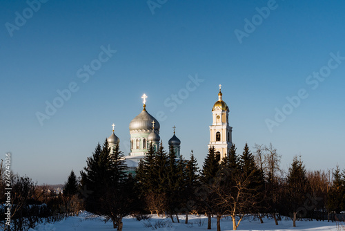 Trinity Cathedral in Diveevo Russia, chapel and bell tower against the background of the blue sky. photo