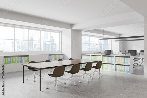 Stylish office interior with meeting table and coworking zone, panoramic window