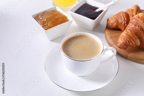 Fototapeta Naklejka Na Ścianę i Meble -  Breakfast time. Fresh croissants, jams and coffee on white table. Space for text