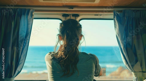 a woman in a motorhome on the background of the sea