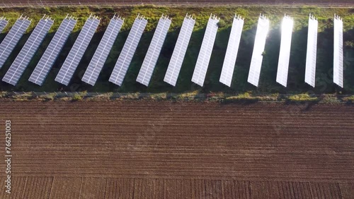 Solar panels farm in the middle of a plowed field
