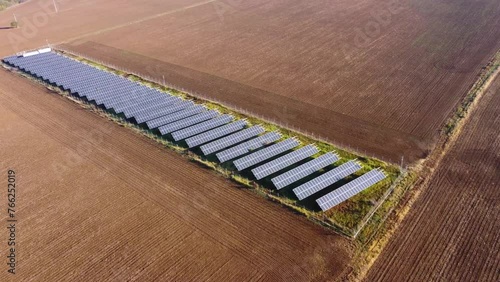 Solar panels farm in the middle of a plowed field