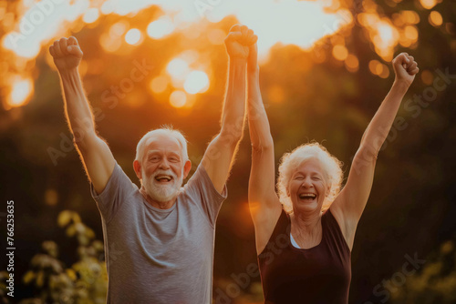 Elderly couple enjoying outdoor exercise together in the park, A couple of older people are smiling and holding hands, celebrating something. Scene is joyful and positive in warm sunset light
