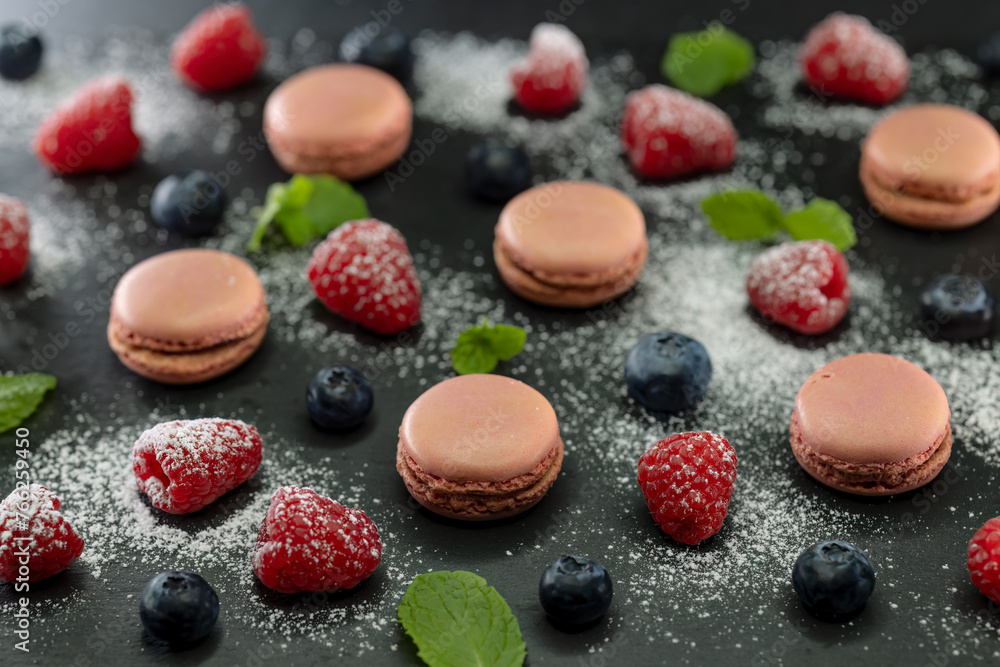 macaroons of different colors on a black background macaroons of different colors on a black background
