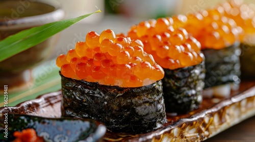 Ikura sushi is a traditional Japanese dish consisting of rice topped with ikura caviar and wrapped in seaweed.