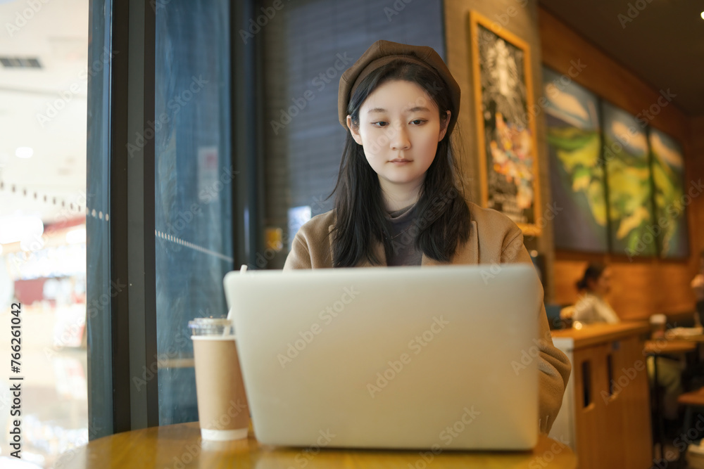 Young Freelancer Engrossed in Work at Cozy Cafe