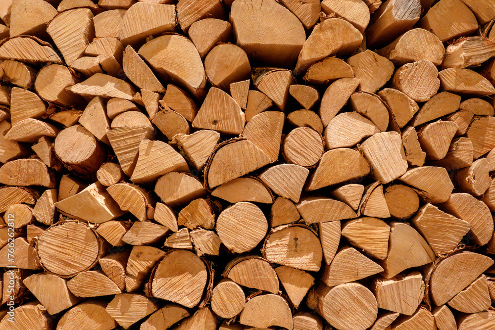 Stacked firewood background of cut wooden log for fireplace Stacked firewood background of cut wooden log for fireplace