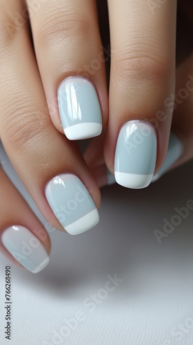 Womans Hand With Blue and White Manicure