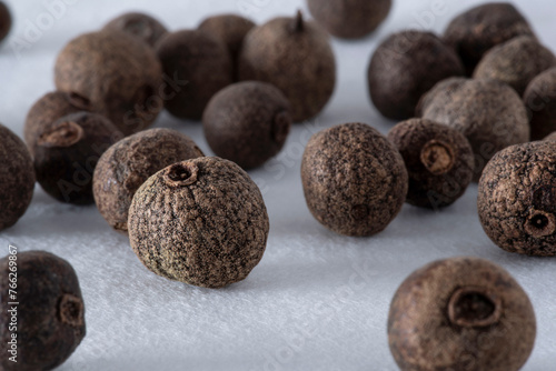 Allspice seeds close-up on white background