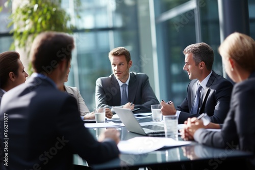 A group of business people are sitting around a table having a meeting