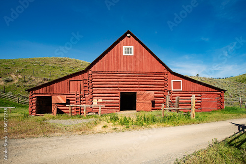 Old red wooden barn under blue sky, Canada