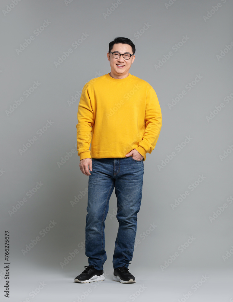 Full length portrait of happy man on grey background Full length portrait of happy man on grey background