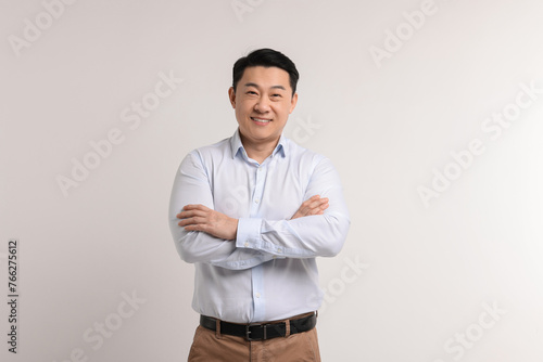 Portrait of happy man on light background © New Africa