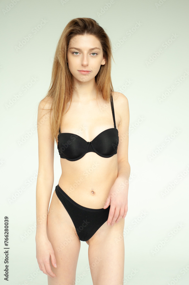 Snap Models. Full length portrait of a beautiful brunette woman in black bikini isolated on white background Snap Models. Full length portrait of a beautiful brunette woman in black bikini isolated on white background