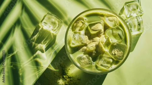 Top view of an iced matcha latte on a pastel green background with ice cubes. Refreshing cold drink. Generative AI